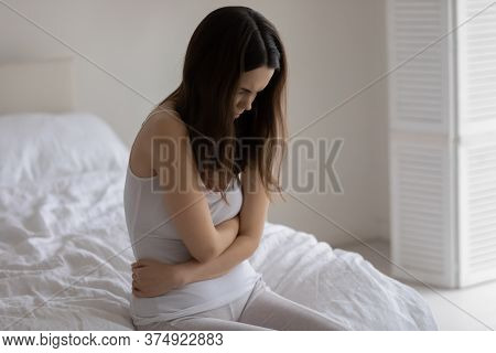 Unhappy Young Woman Touching Stomach, Suffering From Bellyache