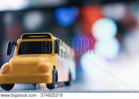 Yellow School Mini Bus Kids Toy, Student Transport For Children Transports Service On Blurred Agains
