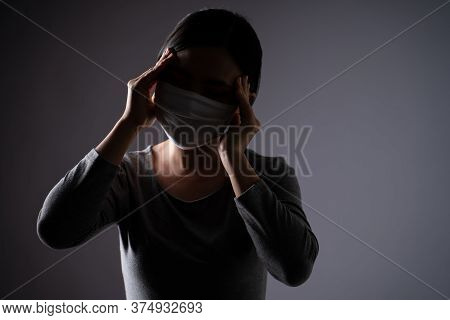 Asian Woman Wearing Protective Face Mask Was Sick With Headache Touching Her Head And Standing Isola