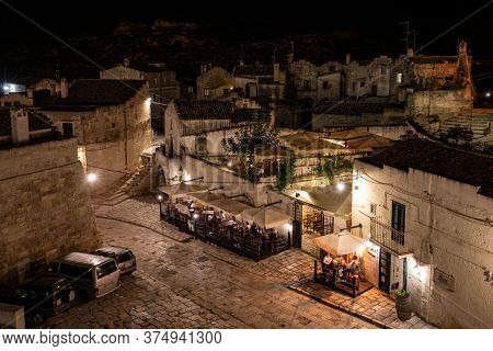 Matera, Italy - September 19, 2019: Evening View Of The City Of Matera, Italy, With The Colorful Lig