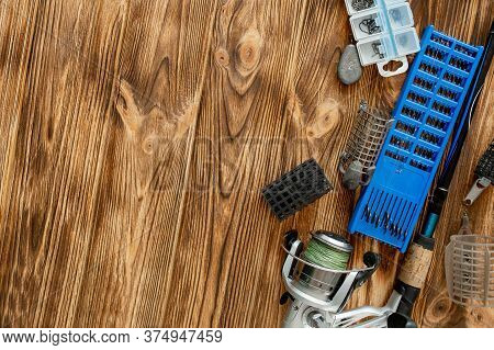 Flat Lay With Fishing Tackle, Fishing Rod And Plastic Box With Fishing Tackle And Hooks, Feeders On 