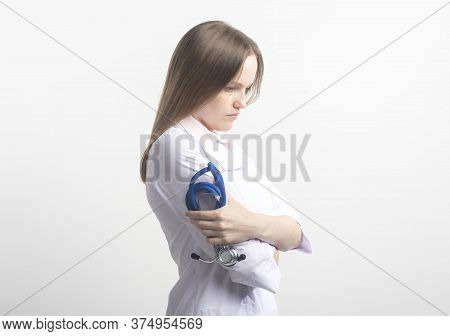 Sad Serious Female Doctor With Arms Crossed Holding Stethoscope And Thinking Isolated On White Backg
