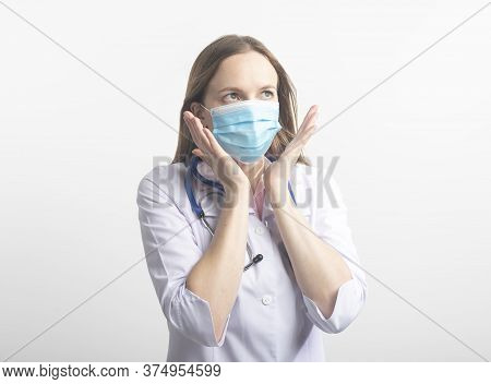 Confused Stressed Young Caucasian Doctor In Protective Facial Mask Isolated On White Background