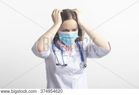 Confused Stressed Tired Young Caucasian Doctor In Protective Facial Mask Isolated On White Backgroun