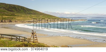 View Of The Beach With A Large Mountain Bordering The Coast. Place Of The Lifeguard. Playa Cayon, Ga