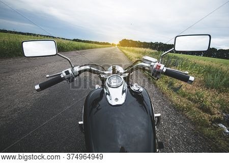 Motorcycle Steering Wheel Against The Rural Asphalt Road. First Person View.