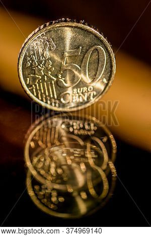 Euro Coins On A Glass Table.