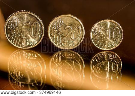 Euro Coins On A Glass Table.
