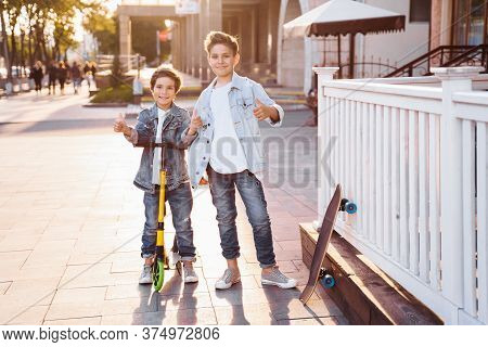 Two Attractive Teenagers Of Caucasian Nationality 7 And 9 Years Old Standing On Sunny Evening Street