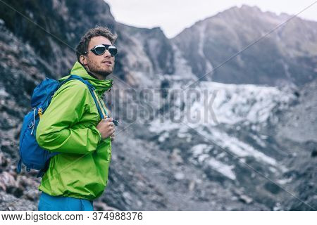 Travel adventure in New Zealand. Tourist explorer backpacking in nature landscape by Franz Josef Glacier, Westland Tai Poutini National Park, South Island, New Zealand.
