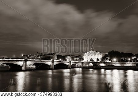 Paris River Seine with Pont de la Concorde and Assemblee Nationale at dusk