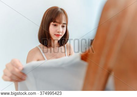 Asian Woman Dress-up At Home. Lifestyle In The Bedroom. Social Distancing And Self-quarantine.