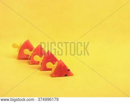Watermelon Slices On An Ice Cream Stick On A Yelloow Background. Creative Idea Top View