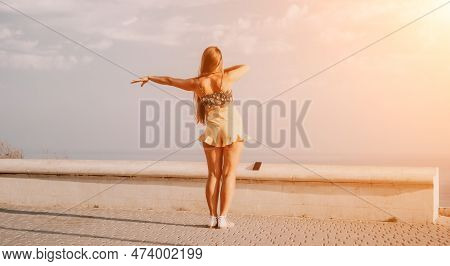 Woman Summer Dance. Silhouette Of A Happy Woman Who Dances, Spins And Raises Her Hands To The Sky. A