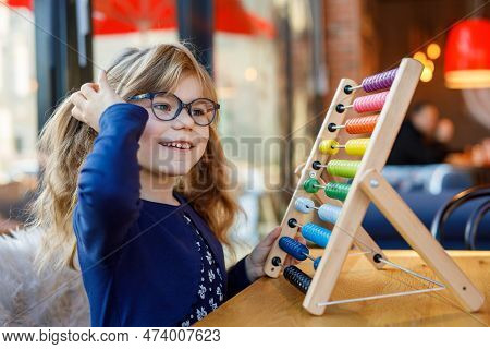 Little Preschool Girl Playing With Educational Wooden Rainbow Toy Counter Abacus. Healthy Happy Chil