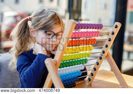 Little Preschool Girl Playing With Educational Wooden Rainbow Toy Counter Abacus. Healthy Happy Chil