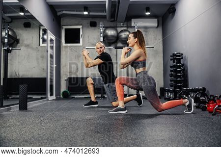 Exercise A Step Forward, The Concept Of Personal Training For Two. A Fitness Man And A Woman Do Spor