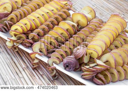 The Fried Potatoes Cut In The Form Of A Spiral On Skewers. Chips Potatoes. Organic Food. Street Food