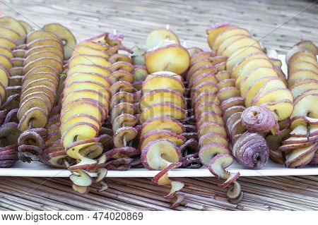 The Fried Potatoes Cut In The Form Of A Spiral On Skewers. Chips Potatoes. Organic Food. Street Food