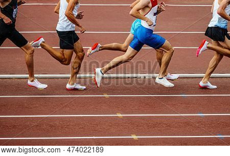 Group Male Runners Running Middle Distance Race Side View, Summer Athletics Championships At Stadium
