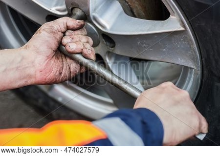Car Wheel Replacement. Self-service Tire Fitting Concept. Installing A New Wheel. Winter And Summer 