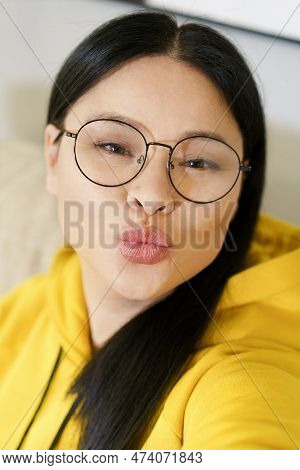Young Pretty Woman Takes Selfies On Her Smartphone And Applies Filters And Portrait Processing Appli