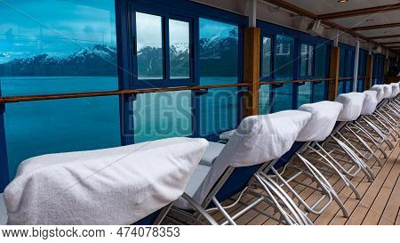Daybeds In Row. Window View To Coastal Landscape Of Fjords And Glaciers From Resort Daybeds