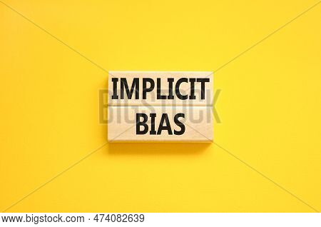 Implicit Bias Symbol. Concept Words Implicit Bias On Wooden Block. Beautiful Yellow Table Yellow Bac