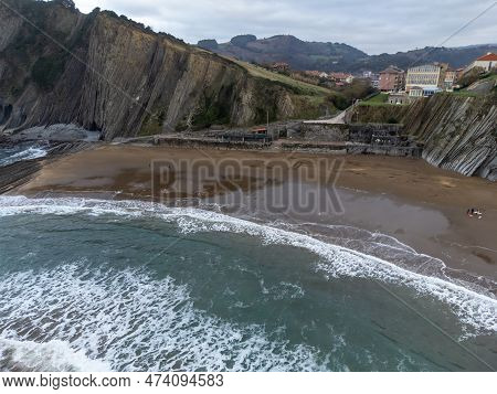 View On Sandy Beach, Rocks And Atlantic Ocean In Zumaia Touristic Ciry, Basque Country, Spain