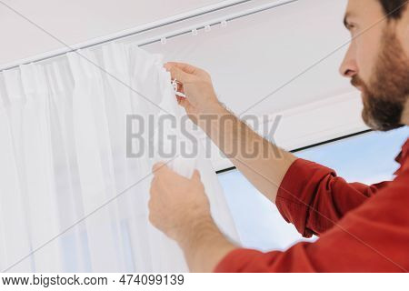 Worker Hanging Window Curtain Indoors, Low Angle View