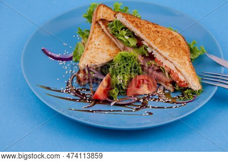 Breakfast Sandwich Toast With Salad. Blue Background. Bread, Beakon Tomatoe On Plate Top View. Meat 