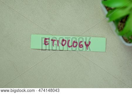 Concept Of Etiology Write On Sticky Notes Isolated On Wooden Table.