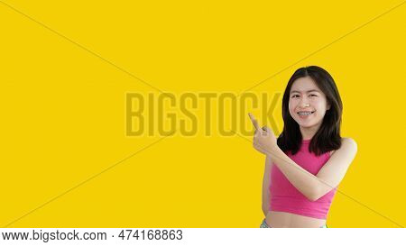 Asian Woman Pointing Finger Inviting Click Here, It Is Recommended To Follow This Direction Or Click