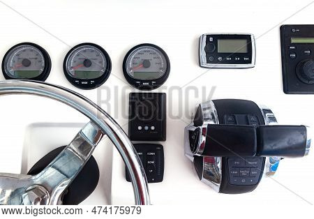 Luxury Yacht Control Panel With Steering Wheel, Gear Levers, Navigation Devices And Control Buttons.