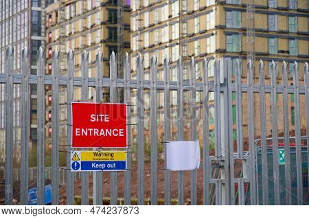 Site Entrance Sign On Fence Boundary At Construction Site