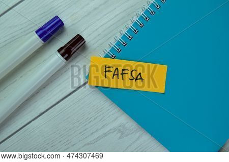 Concept Of Fafsa Write On Sticky Notes Isolated On Wooden Table.