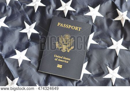 Us Citizen's Passport. Top View On The Background Of Part Of The American Flag. Selective Focus.