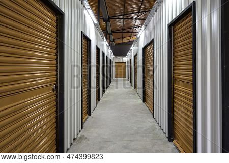 Corridor Of Self Storage Unit With Red Doors. Rental Storage Units