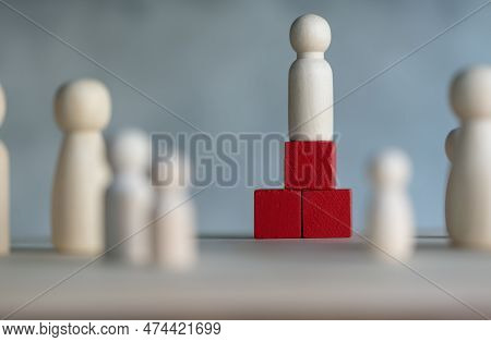 Wooden Figures And Peg Dolls Standing On The Red Podium 1st Positions Of Wooden Cube Blocks. Ranking