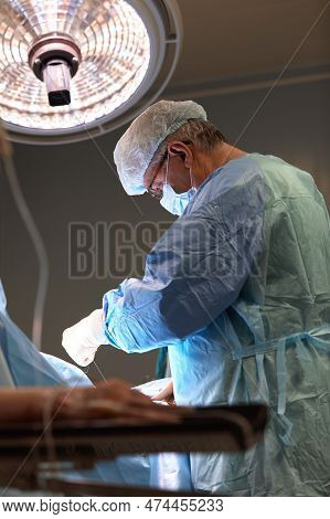 Surgeon Face In Operating Room, Stressful Operation, Surgeon Performs Operation In Modern Operating 
