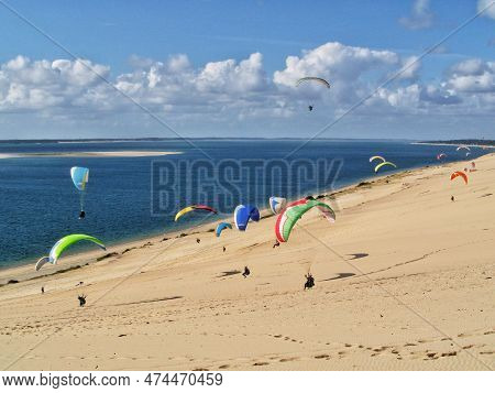 People Paragliding At The Great Dune Of Pilat, Arcachon Basin, Nouvelle Aquitaine, France.
