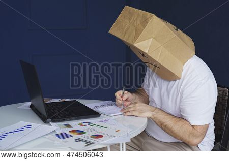 A Man - A Businessman In A White Shirt With A Paper Bag On His Head, With A Sad Smiley Face Drawn, W