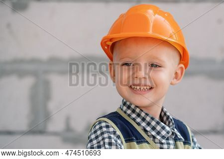 Kid In Hard Hat Holding Hammer. Happy Smiling Little Child Helping With Toy Tools On Construciton Si