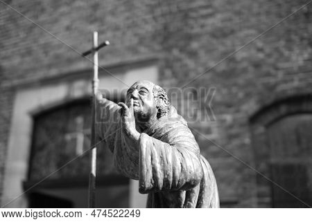 Bronze Sculpture Of A Silent Monk With A Cross In His Hand In Venlo, Netherlands