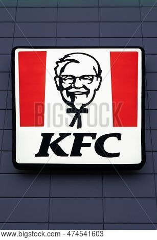 Kfc Logo On A Facade. Kfc Is A Fast Food Restaurant Chain That Specializes In Fried Chicken And Is H