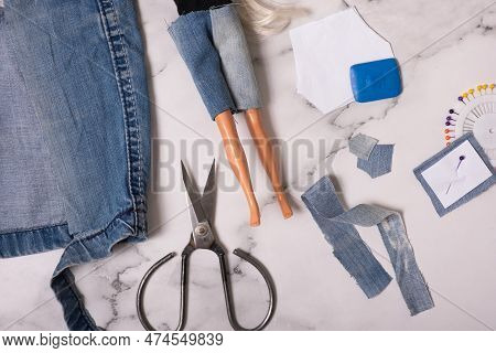 Sewing Doll Clothes From Worn Denim Shorts. Reusing Thing, Resycling Concept