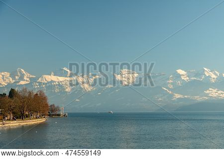 Thun, Switzerland, February 12, 2023 Fantastic View Over The Snow Covered Alps From The Schadau Park