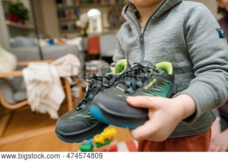 Frankfurt, Germany - Mar 12, 2023: A Child Showing Modern, Stylish Lowa Boots With Vibrant Blue And 