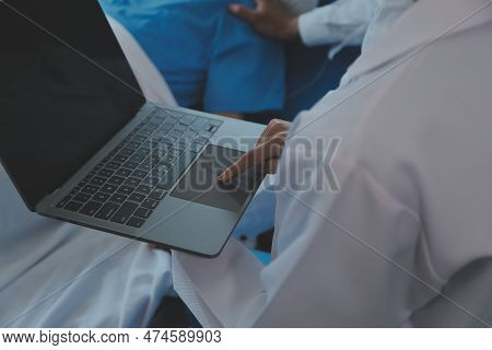 Injured Patient Showing Doctor Broken Wrist And Arm With Bandage In Hospital Office Or Emergency Roo