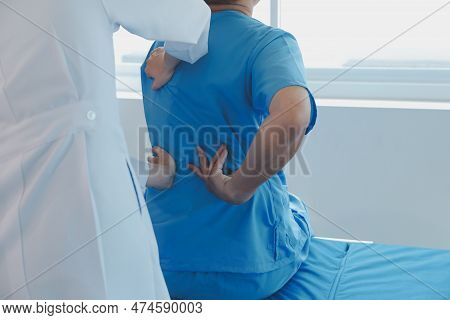 Patient Doing Some Special Exercises Under Supervision In A Room.